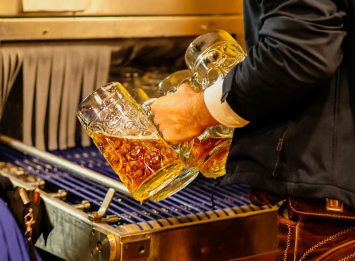 Beer mugs being filled with beer.jpg