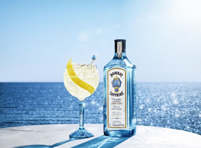 Premium gin bottles with juniper berries, citrus peel and botanical ingredients