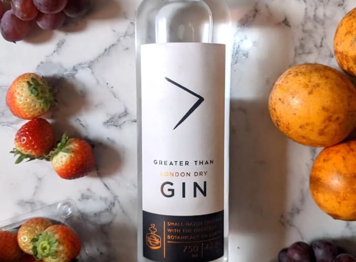 Premium gin bottles with juniper berries, citrus peel and botanical ingredients