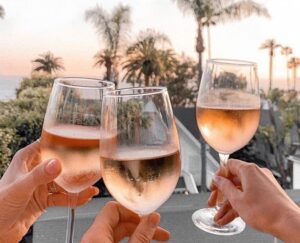 Rosé wine glasses in hands