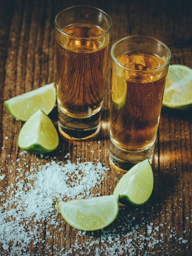 Two glasses of tequila with lime and salt