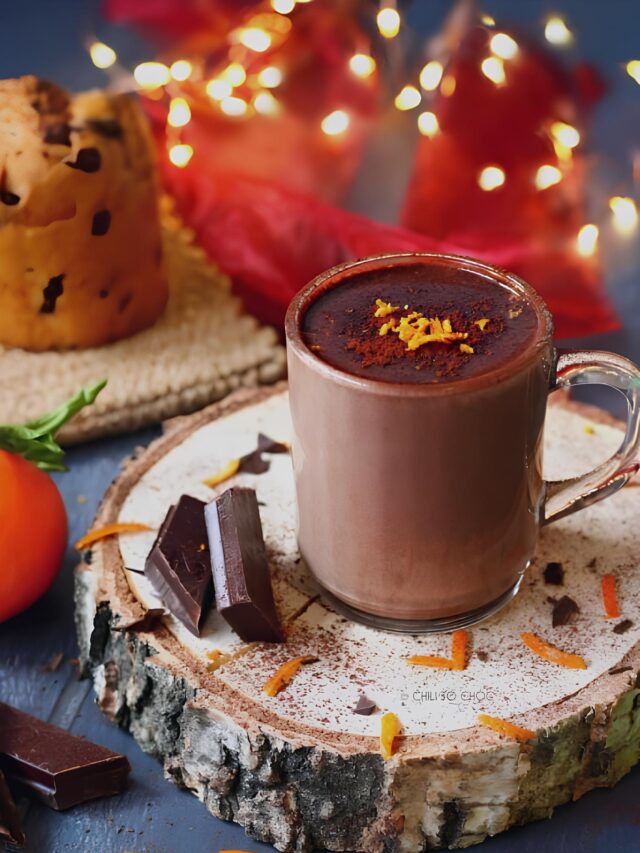 A mug of Orange Infused Hot Toddy Chocolate with orange zest as garnish.