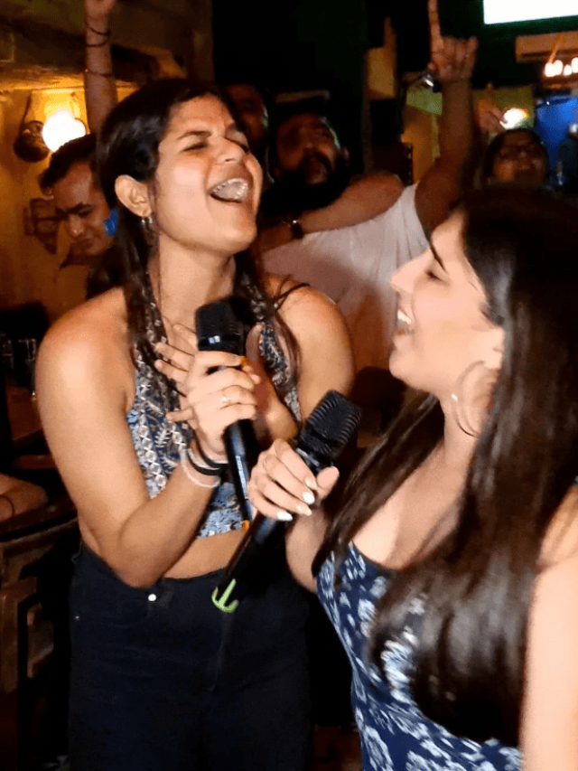 2 women singing in a bar