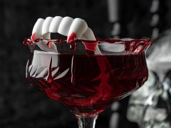 Dark red cocktail with fake vampire teeth