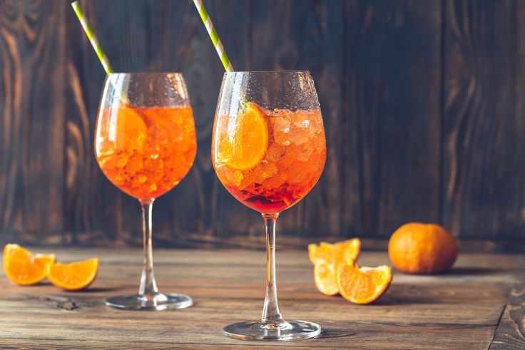 Two glasses of Aperol Spritz with slices of orange. A refreshing aperitif drink for summer afternoons. 