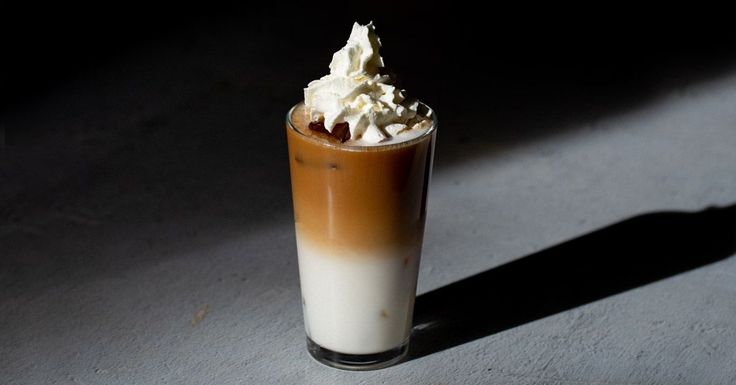 The Anaïs Nin is a brown and white colored sambuca cocktail containing creme de banane liqueur, coffee and sambuca. It is topped with whipped cream. 