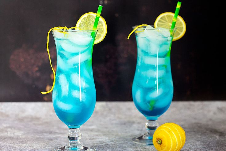 Two glasses of Blue lagoon, one of the beach-themed cocktails