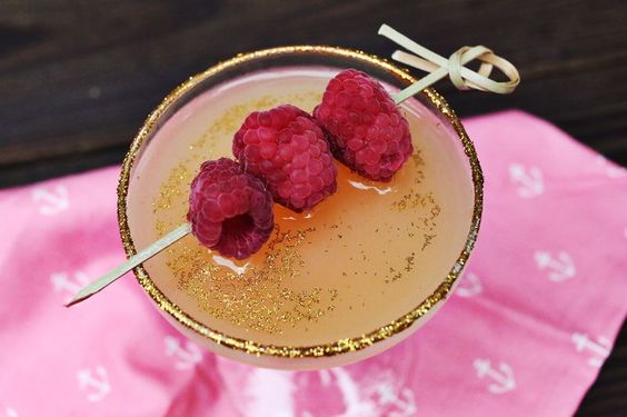 A glass of Champagne Royal D'Oro garnished with edible gold.