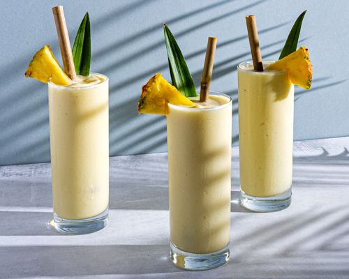 Piña Colada, a popular pineapple flavored cocktail, served in tall glasses.