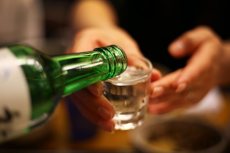 In Korean drinking culture, the drinking glass is held with both hands when being poured into.