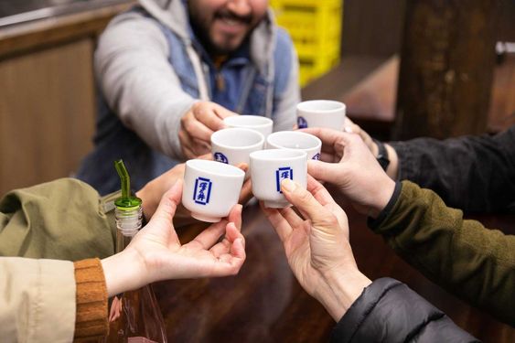 People toasting with Japanese drinking cups