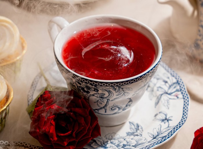 Cocktail drink served in a tea cup and saucer at Onrique