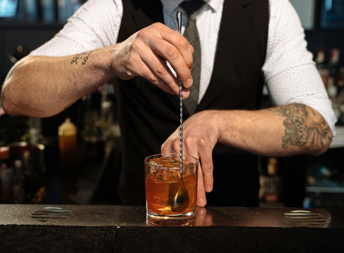 A bartender at a speakeasy bar