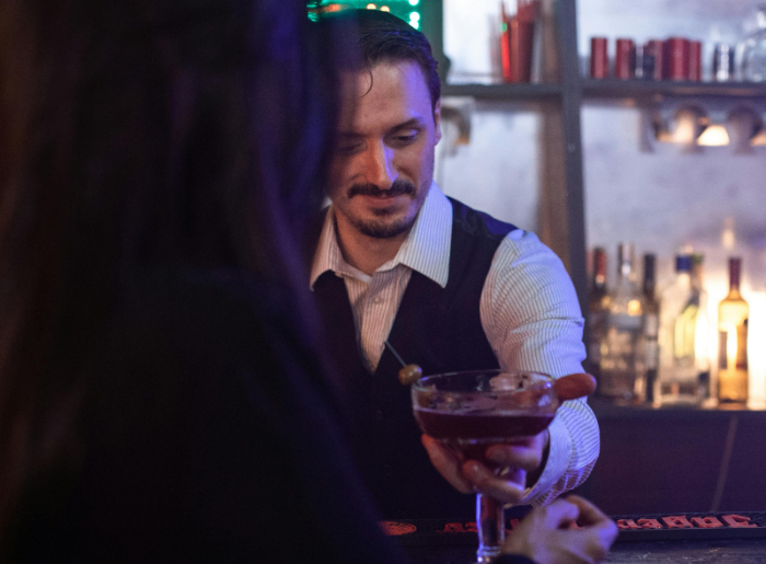 Bartender serving a drink